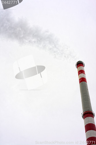 Image of Industrial chimney against cloudy sky