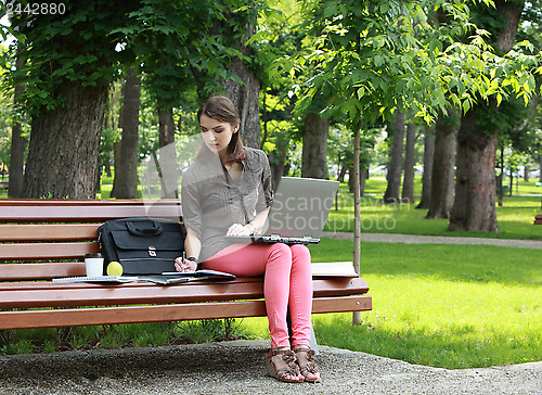 Image of Young Woman Studying in a Park