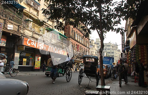 Image of Rickshaw man pulls the customer in the streets of Kolkata