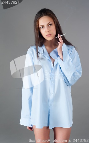 Image of beautiful young brunette woman with cigarette