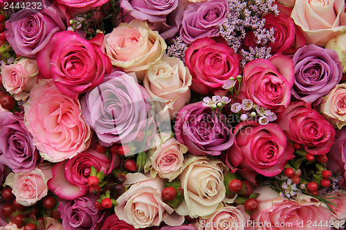 Image of purple and pink roses wedding arrangement