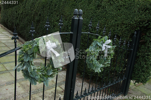 Image of Christmas decorations on a fence