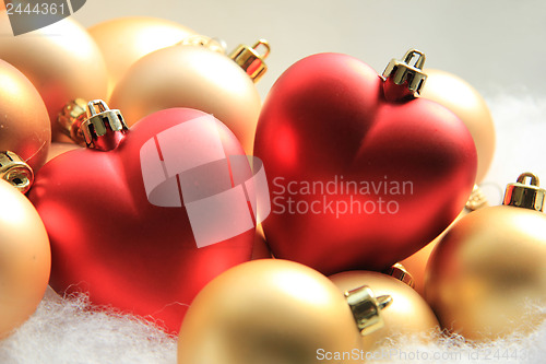 Image of red heart shaped christmas ornaments