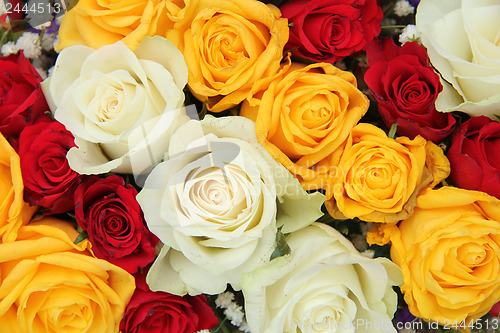 Image of Yellow, white and red roses in a wedding arrangement