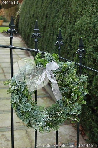 Image of Christmas wreath on a fence
