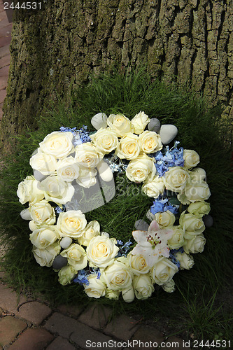 Image of White roses on a sympathy wreasth