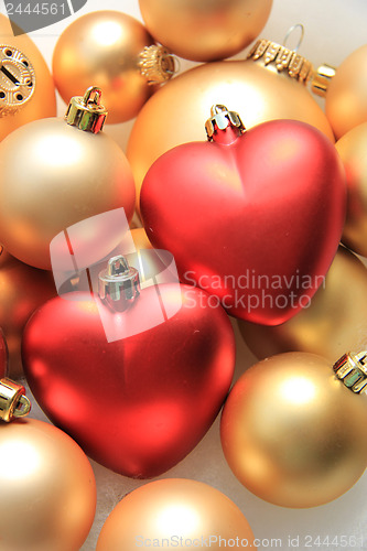 Image of red heart shaped christmas ornaments