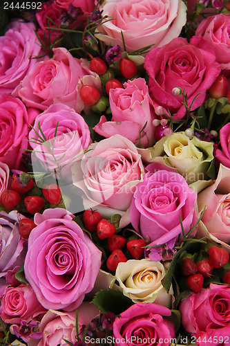 Image of Pink and purple roses in a wedding centerpiece