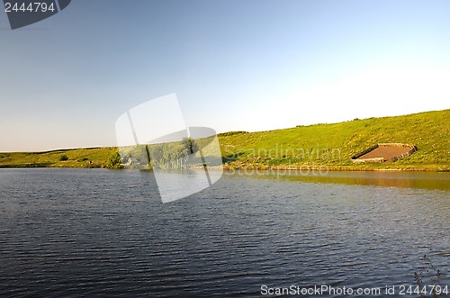 Image of Lake near green meadow