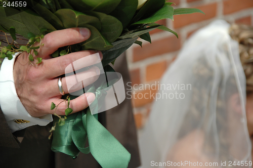 Image of Groom holding flowers