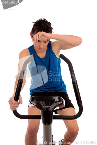 Image of Exhausted after workout on exercise bike