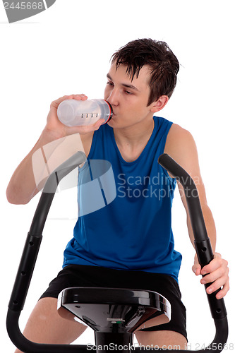 Image of Teenager using exercise bike fitness gym