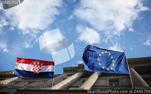 Image of Flags with cloudy sky