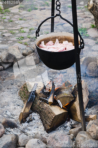 Image of old pot for cooking over a campfire, close-up. 