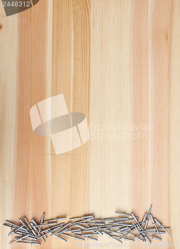 Image of Metal pop rivets on wood