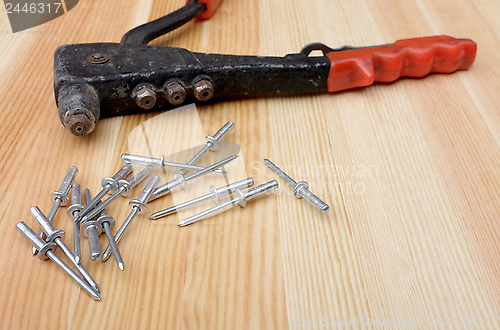 Image of Closeup of pop rivets and riveter