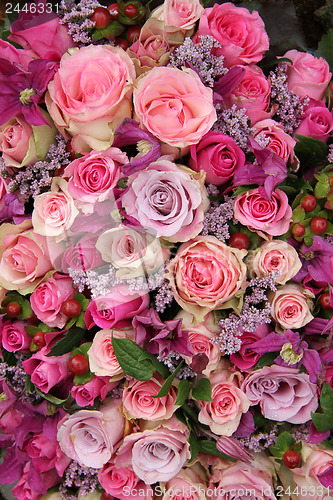 Image of purple and pink roses wedding arrangement