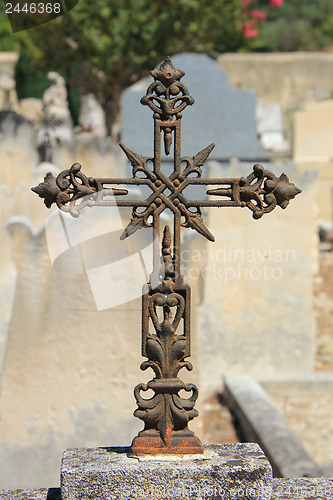 Image of Tombstone with cross ornament at a French cemetery