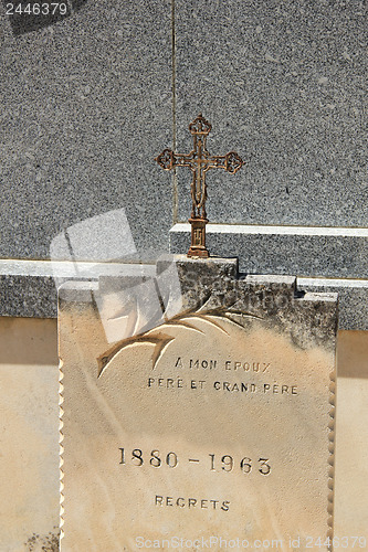 Image of Tombstone with cross ornament at a French cemetery