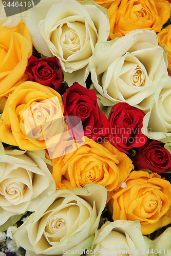 Image of Yellow, white and red roses in a wedding arrangement