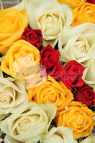 Image of Yellow, white and red roses in a wedding arrangement