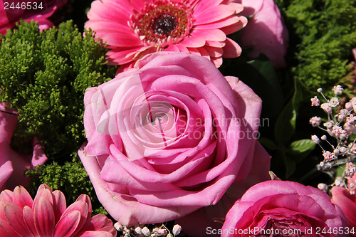 Image of Pink rose in a bridal arrangement