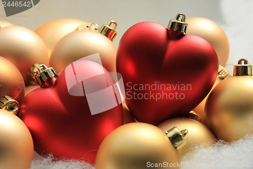 Image of red heart shaped christmas ornaments