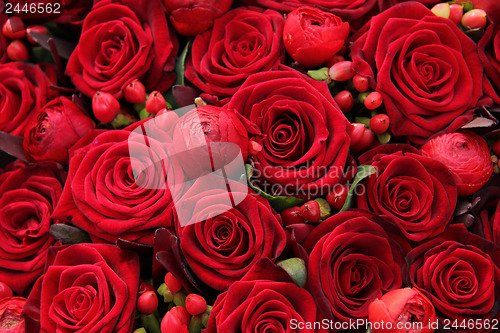 Image of ranunculus, berries and roses in a group