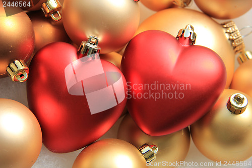Image of red heart shaped christmas ornaments