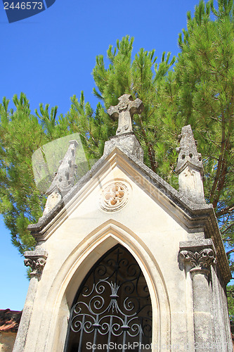 Image of Tombstone with cross ornament at a French cemetery
