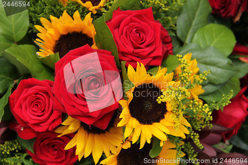 Image of Red roses and sunflowers in a floral arrangement