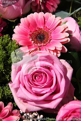 Image of Ranunculus, roses and gerberas in a wedding arrangement