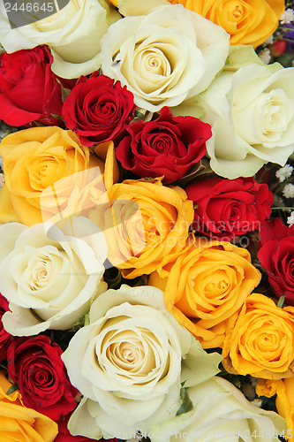 Image of Yellow, white and red roses in a wedding arrangement