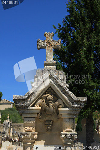 Image of Tombstone with cross ornament at a French cemetery