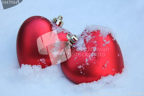 Image of Two red hearts in the snow