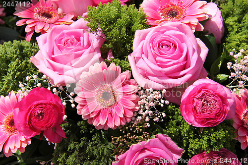 Image of Ranunculus, roses and gerberas in a wedding arrangement