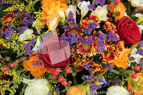 Image of Mixed floral arrangement in yellow, red and white