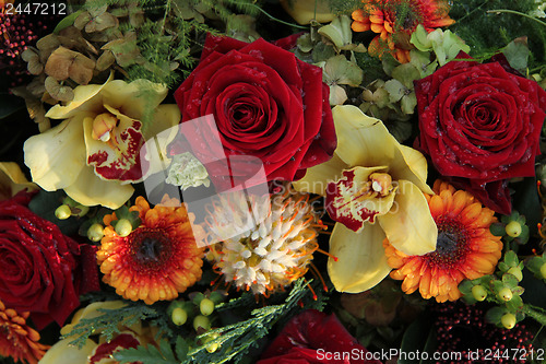 Image of roses and orchids in a flower arrangement