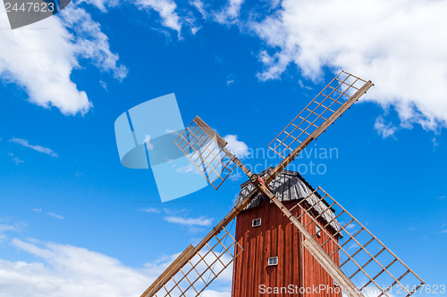 Image of Wooden windmill under blue sky