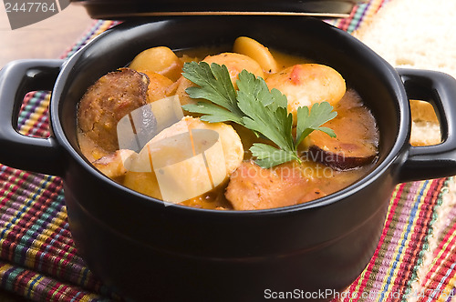 Image of Beans with sausage, bacon and tomatoes