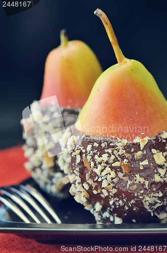 Image of two fresh pear with chocolate icing 