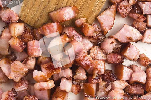 Image of Macro photo of bacon being fried in a pan