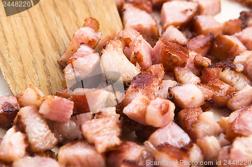 Image of Macro photo of bacon being fried in a pan