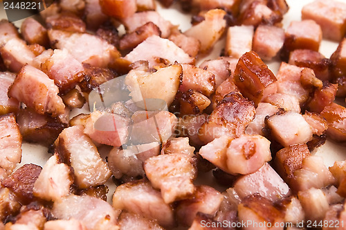 Image of Macro photo of bacon being fried in a pan