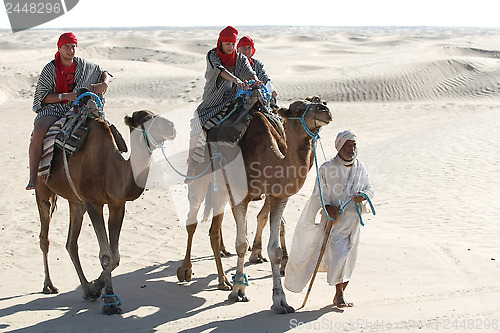 Image of Beduin leading tourists on camels