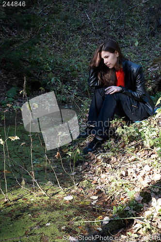 Image of Girl seating near pond