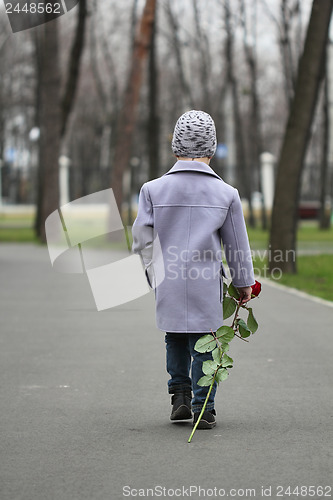 Image of Little boy walking the park