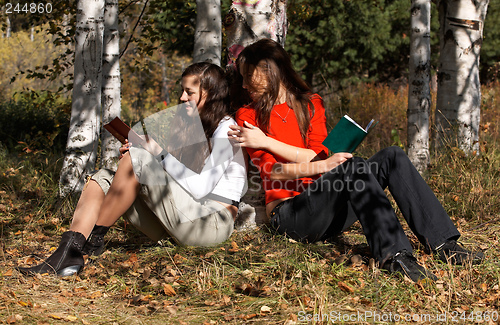 Image of Girls reading  in the park