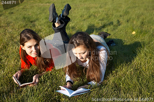 Image of Girls reading the books on the lawn