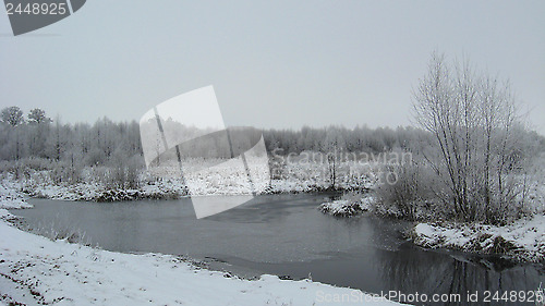 Image of Winter landscape with unfrozen river and snow